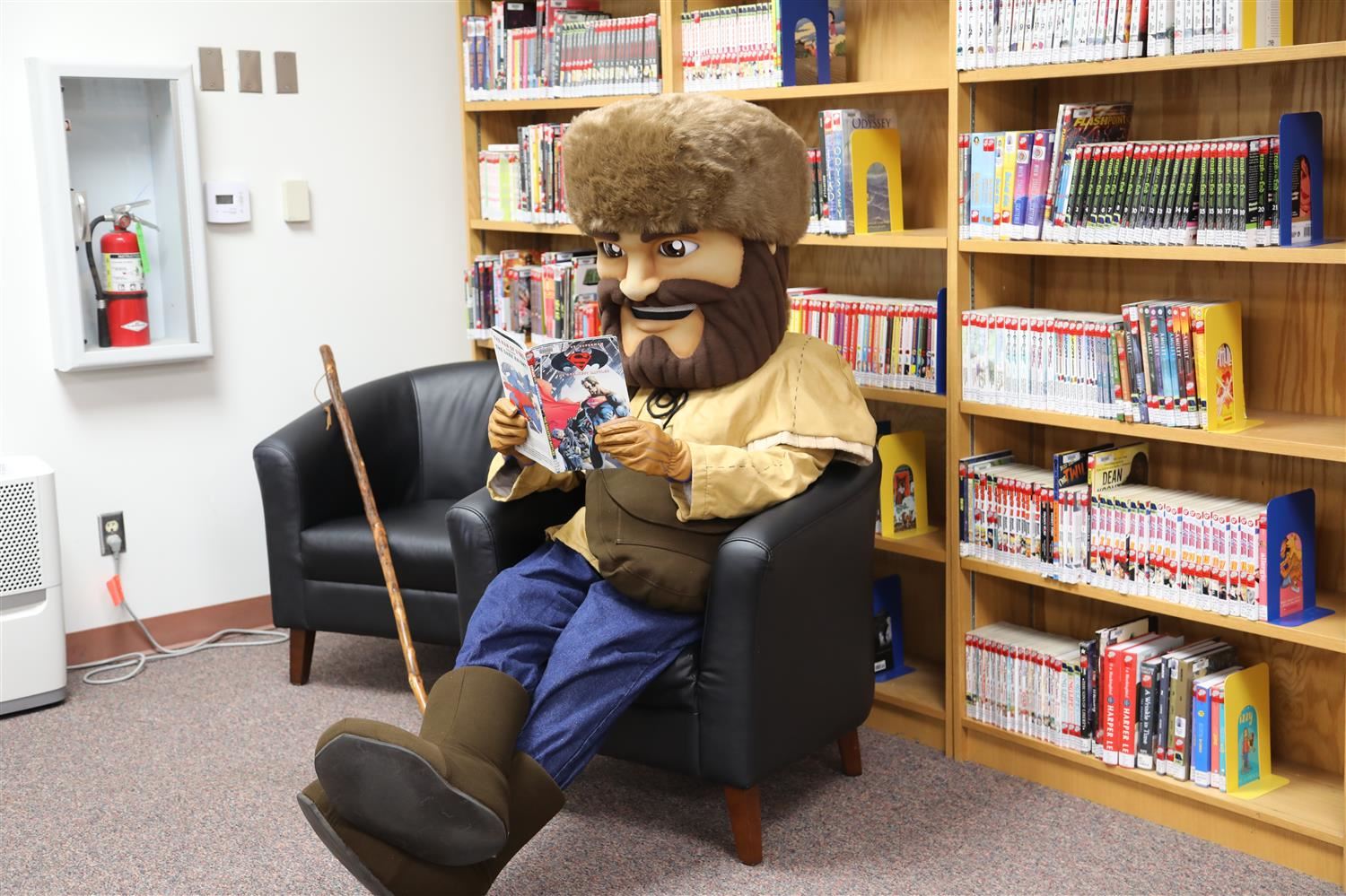Peter Pioneer Reading a Book in the SJHS Library