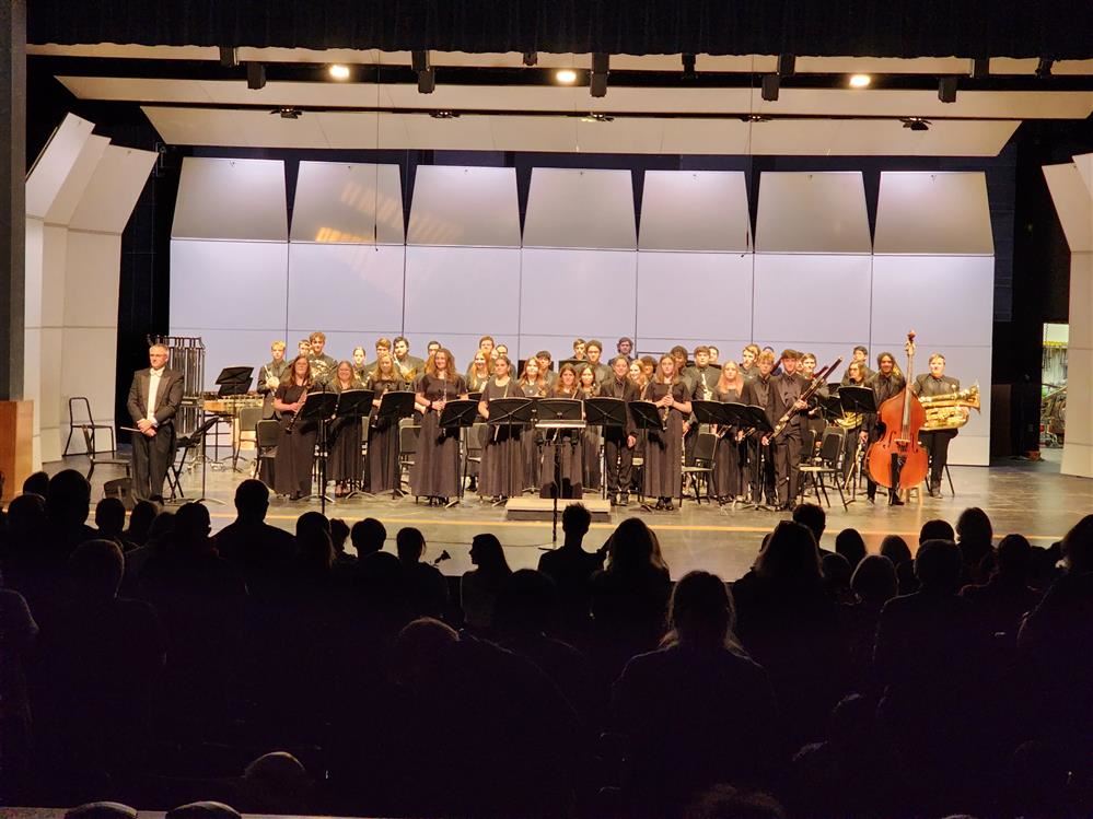  SHS Wind Ensemble musicians performing on their home stage in the SHS Performing Arts Center	