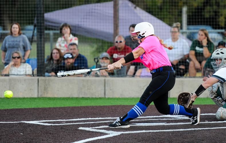  Softball player swinging bat