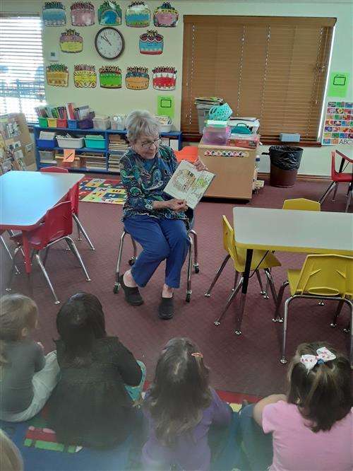Resident reading to students